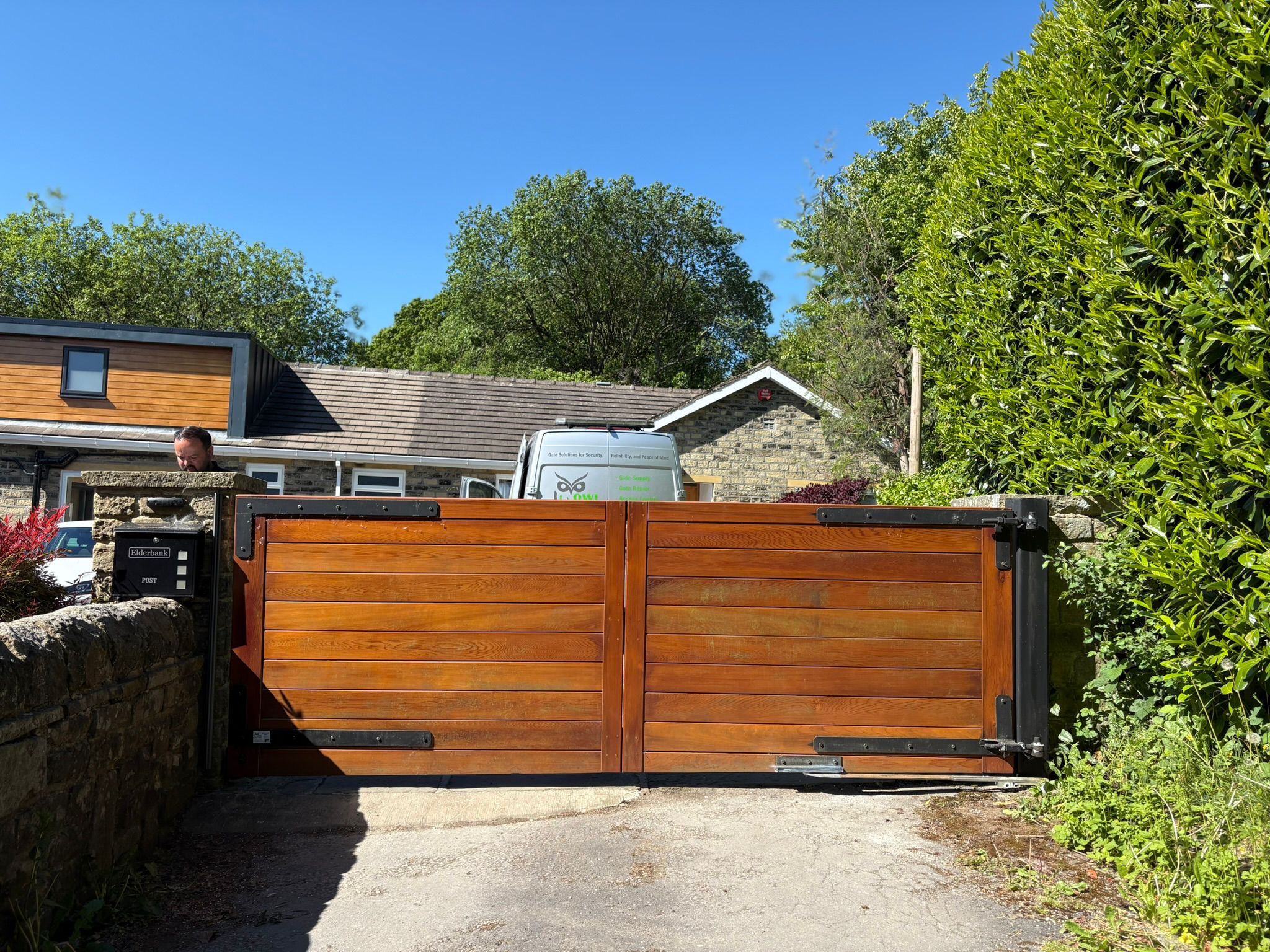 This image features a large double swing gate, with intercom.
