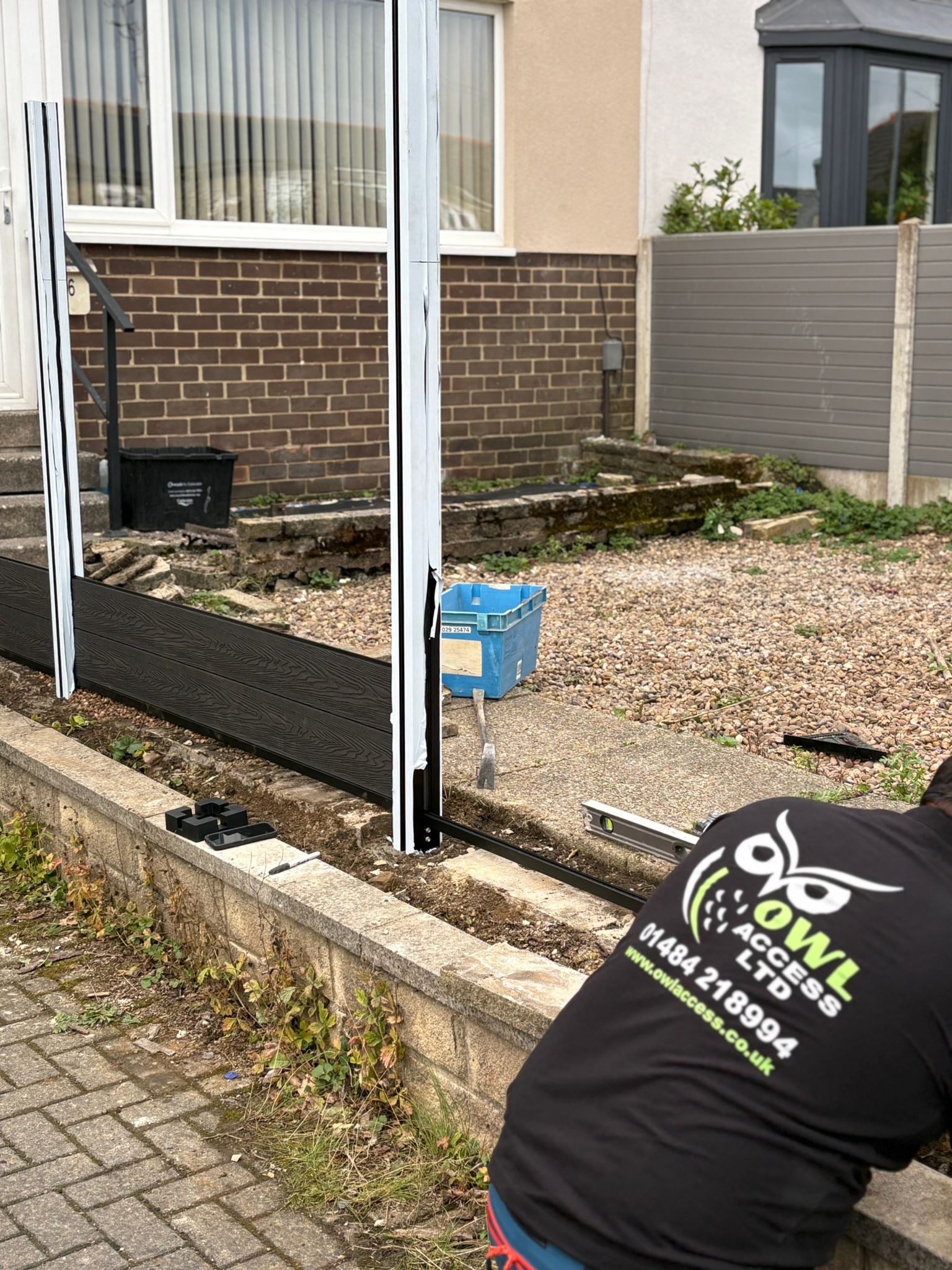 This image shows a new composite fence being installed.