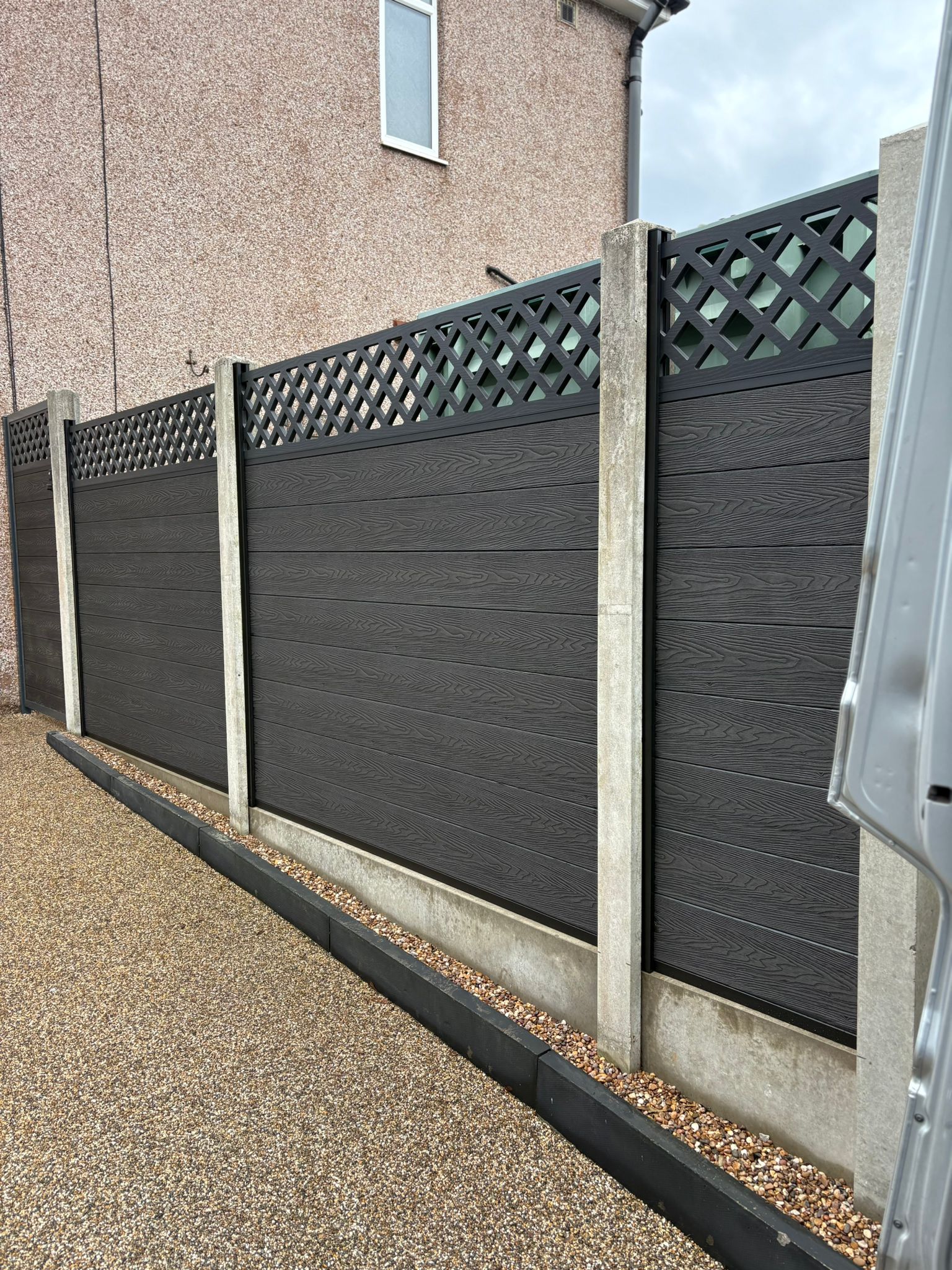 This image shows a newly installed composite fence.