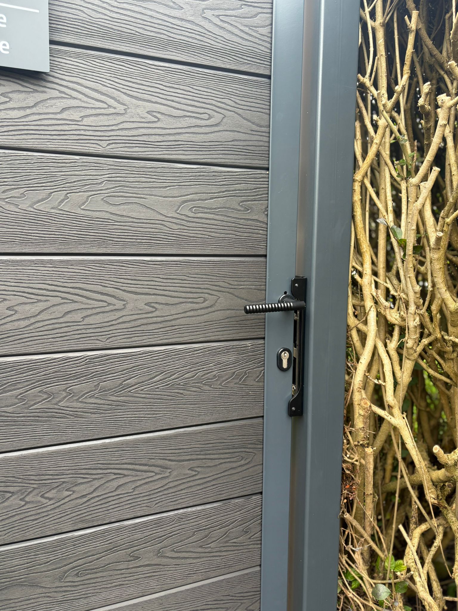 This image shows a secure lock, installed on a newly installed composite gate.