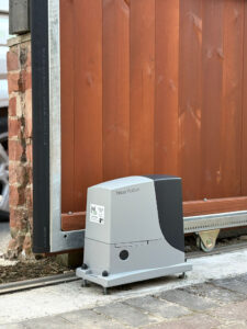This image features a large automated gate, using a Nice Robus sliding gate operator, and SENTIR safety strips.